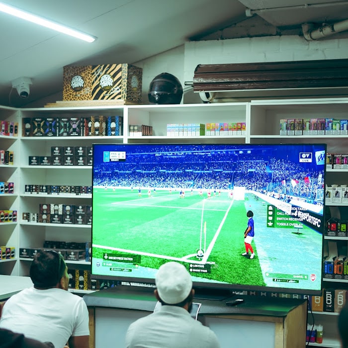 Spectators watching an fc 26 match on the big screen at the advapes tournament